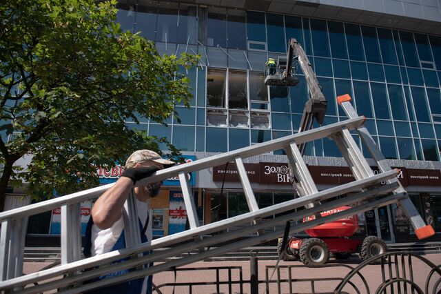 Local services clean up the city after massive shelling in Chernihiv, Ukraine, on Monday, July 4, 2022.