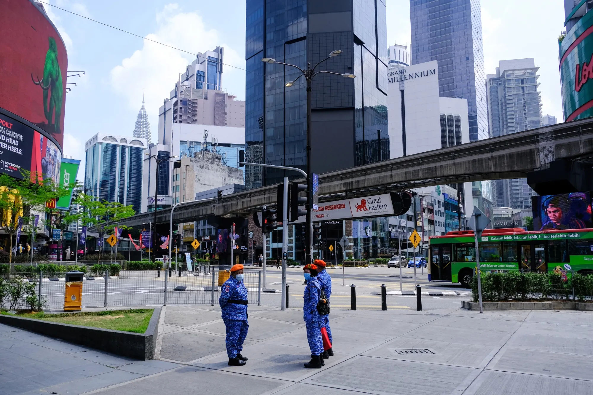 Members of the Malaysia Civil Defence Force&nbsp;wearing protective masks stand guard in the Bukit Bintang area of Kuala Lumpur, Malaysia, on March 22.
