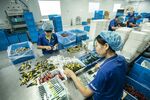 Employees handle toothbrushes on the production line of the Yangzhou Shuguang Toothbrush factory in Yangzhou.