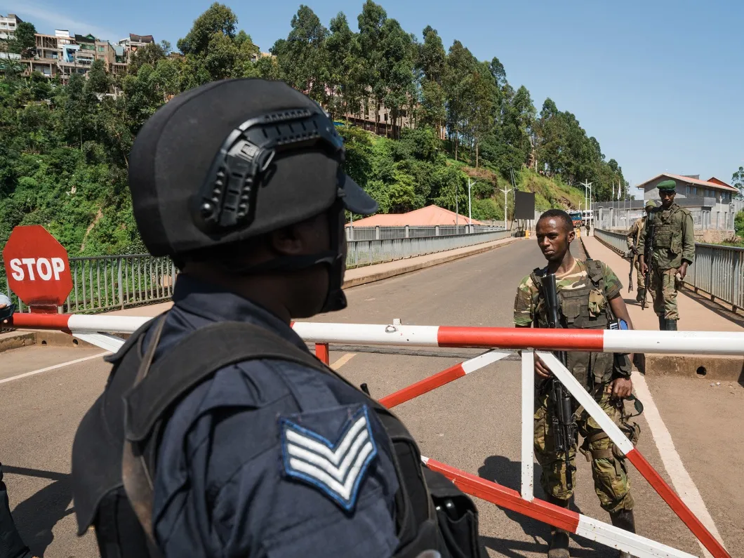 A Rwandan National Police officer watches M23 rebel troops arrive at the Rusizi border post joining Democratic Republic of Congo&nbsp;and Rwanda&nbsp;on Feb. 16.