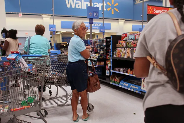 Wal-Mart store shoppers queue up to checkout in Pompano Beach, Florida