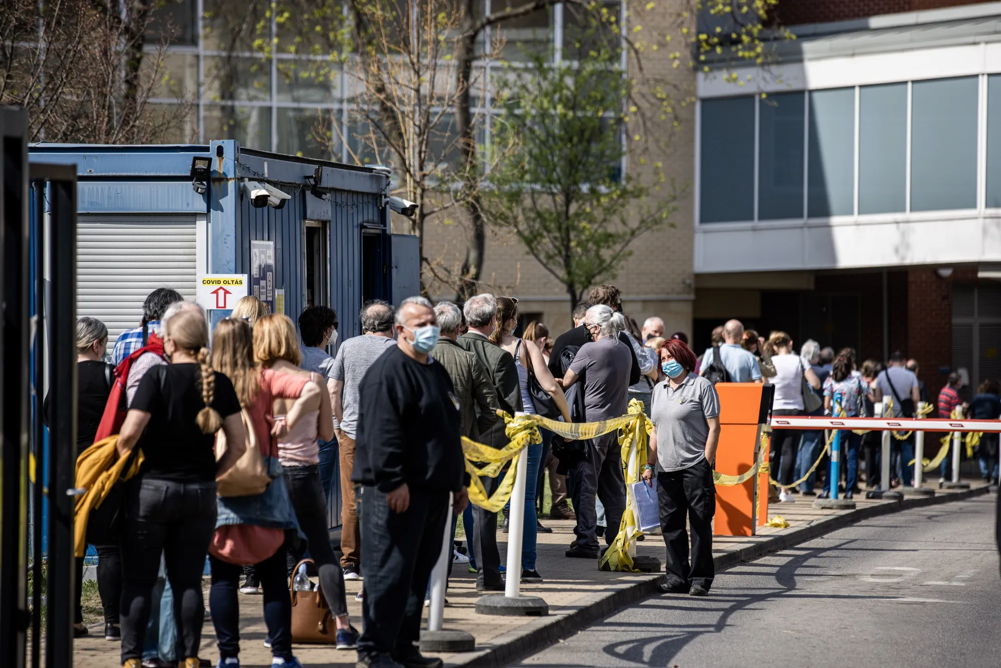 Patients wait in line outside a vaccination point at Semmelweis University Hospital in Budapest.