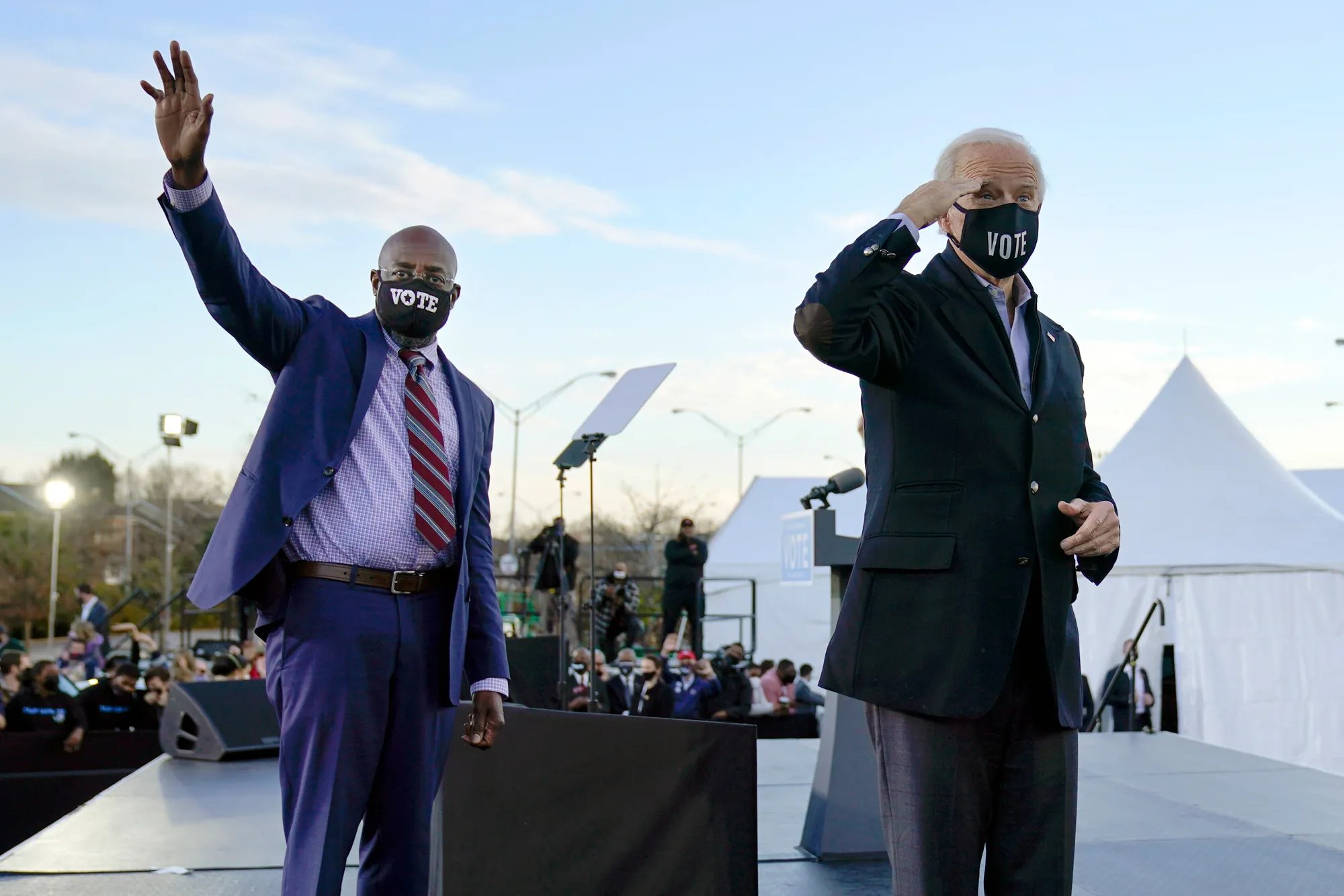 Joe Biden, right, campaigns with Raphael Warnock, left, and Jon Ossoff, not pictured, in Atlanta on Jan. 4.
