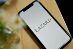 The Lazard logo on a smartphone arranged in the Brooklyn borough of New York, US, on Friday, April 28, 2023. Lazard Ltd. posted a surprise loss for the first quarter and said it plans to reduce its workforce by 10% this year, predicting the industrys dealmaking slump will last through 2023. Photographer: Gabby Jones/Bloomberg