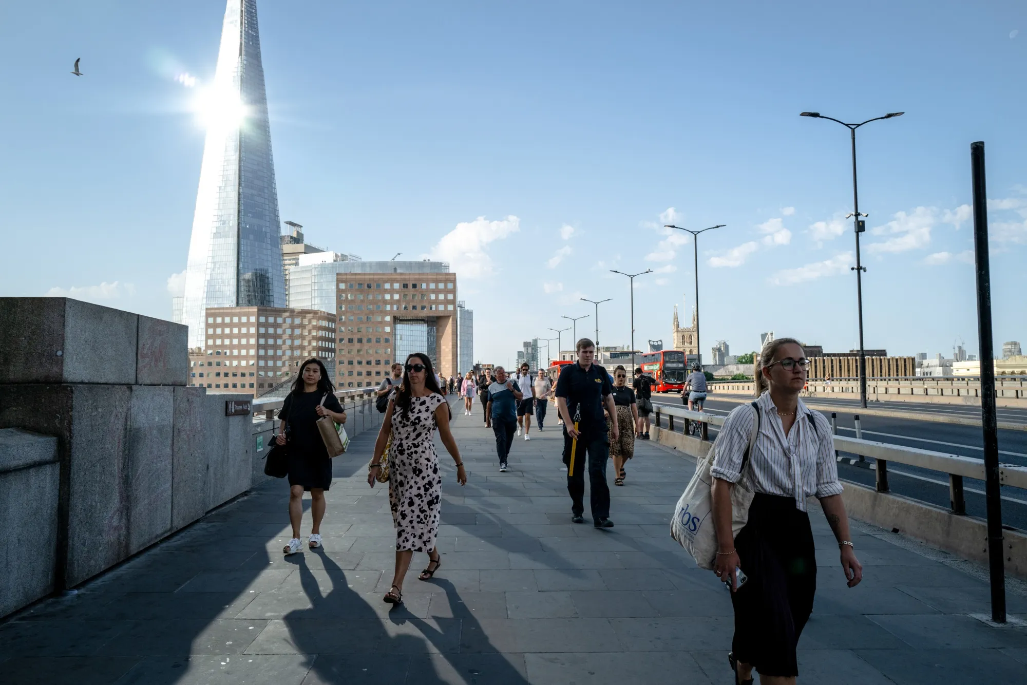 City workers cross London bridge in the morning during a heat wave in London&nbsp;on Monday, July 18, 2022.&nbsp;