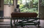 Workers prepare to put the coffin of a Covid-19 victim into an incinerator at the Horto da Paz crematorium in Sao Paulo, Brazil, on June 5.