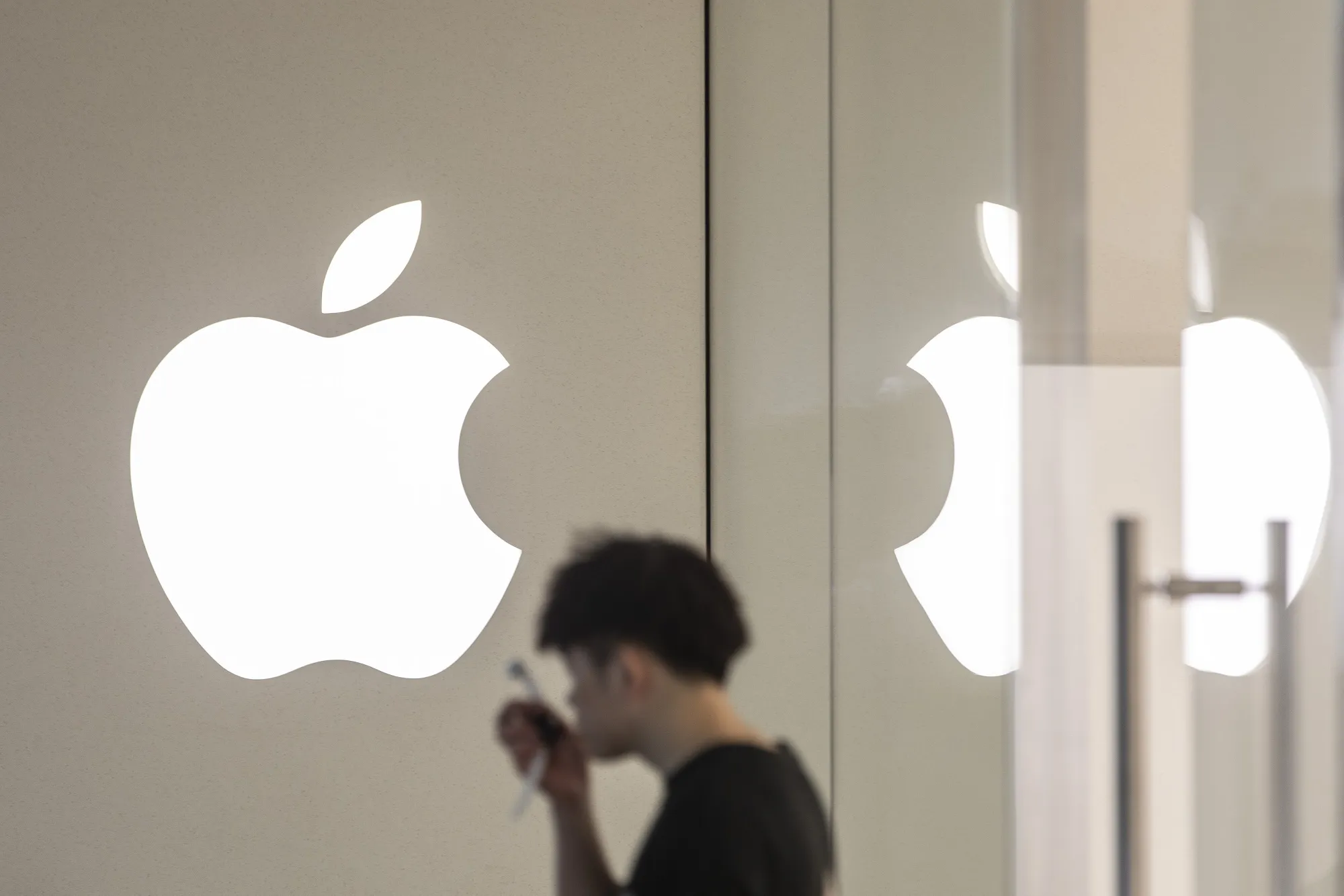 Signage for Apple Inc. is displayed outside a store in Xiamen, China.