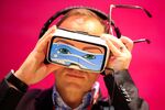 A delegate tries on a Samsung Gear VR headset at Mobile World Congress.
