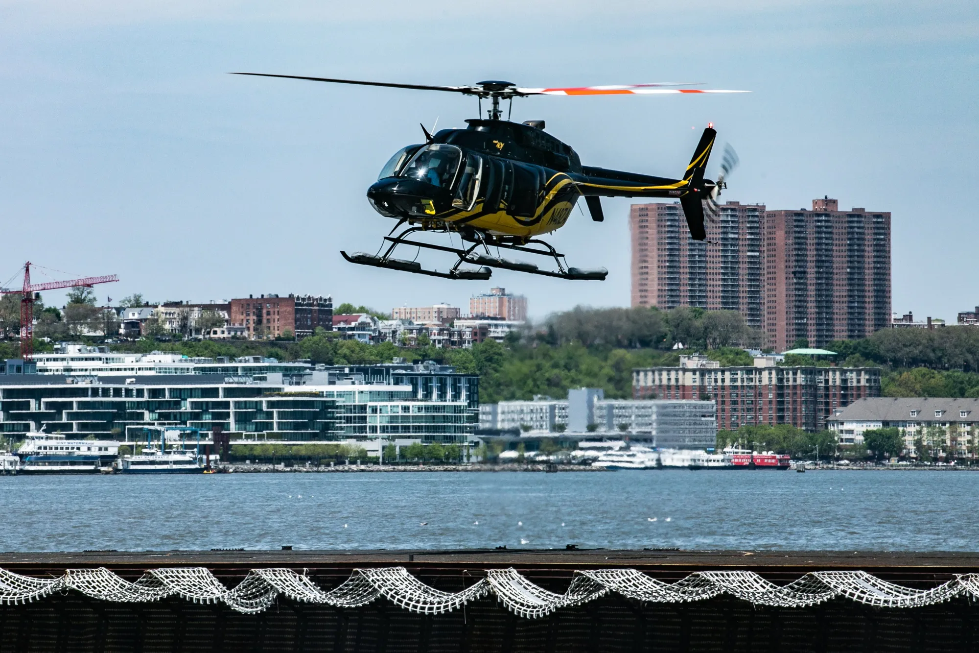 A Bell 407 helicopter arrives at the Blade Lounge West landing area in New York City.