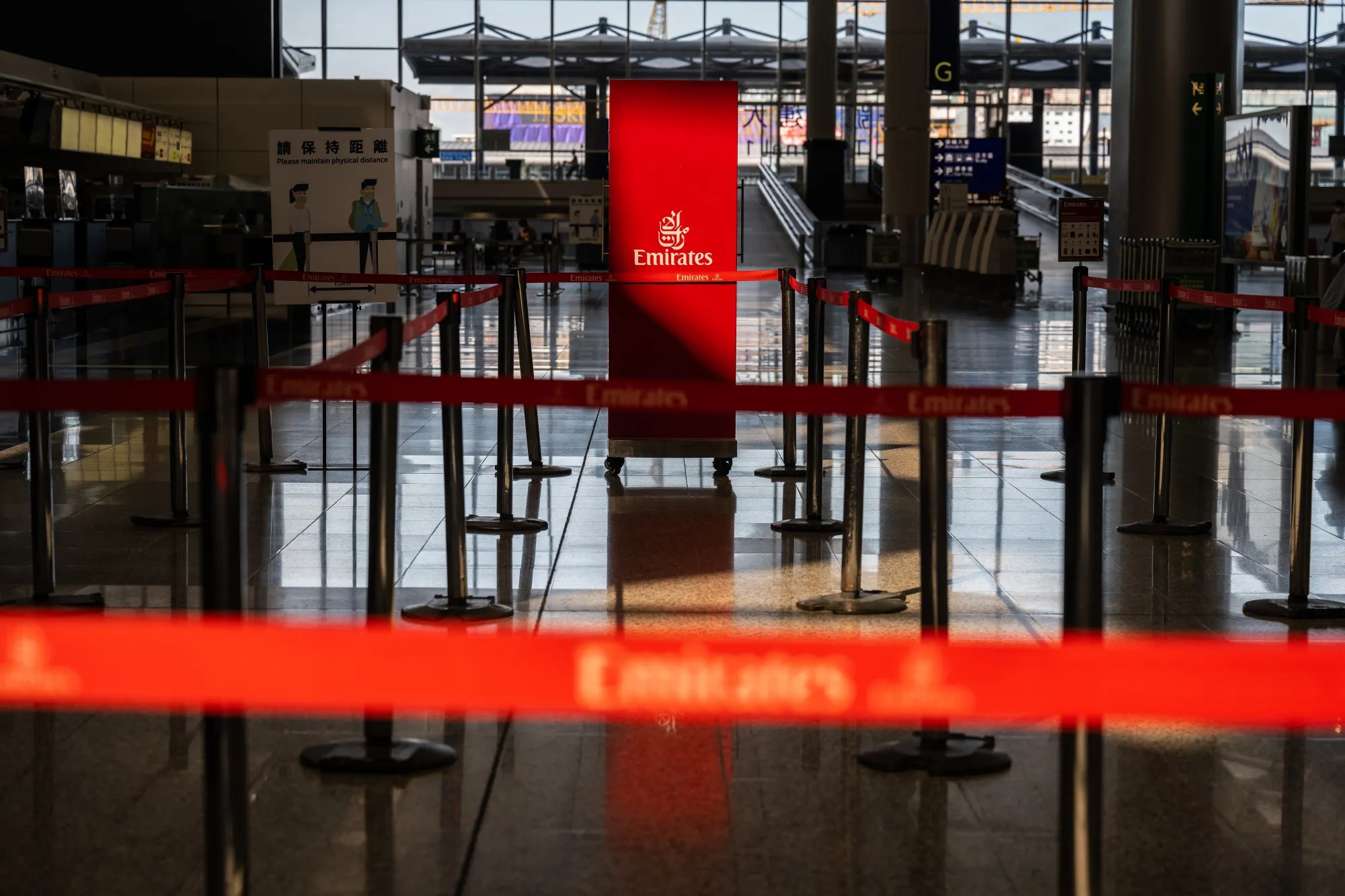 An closed Emirates Airline check-in counter at Hong Kong International Airport.