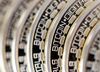 The embossed word Bitcoin sits on the edge of Bitcoins stacked in this arranged photograph in Danbury, U.K., on Thursday, Dec. 10, 2015.