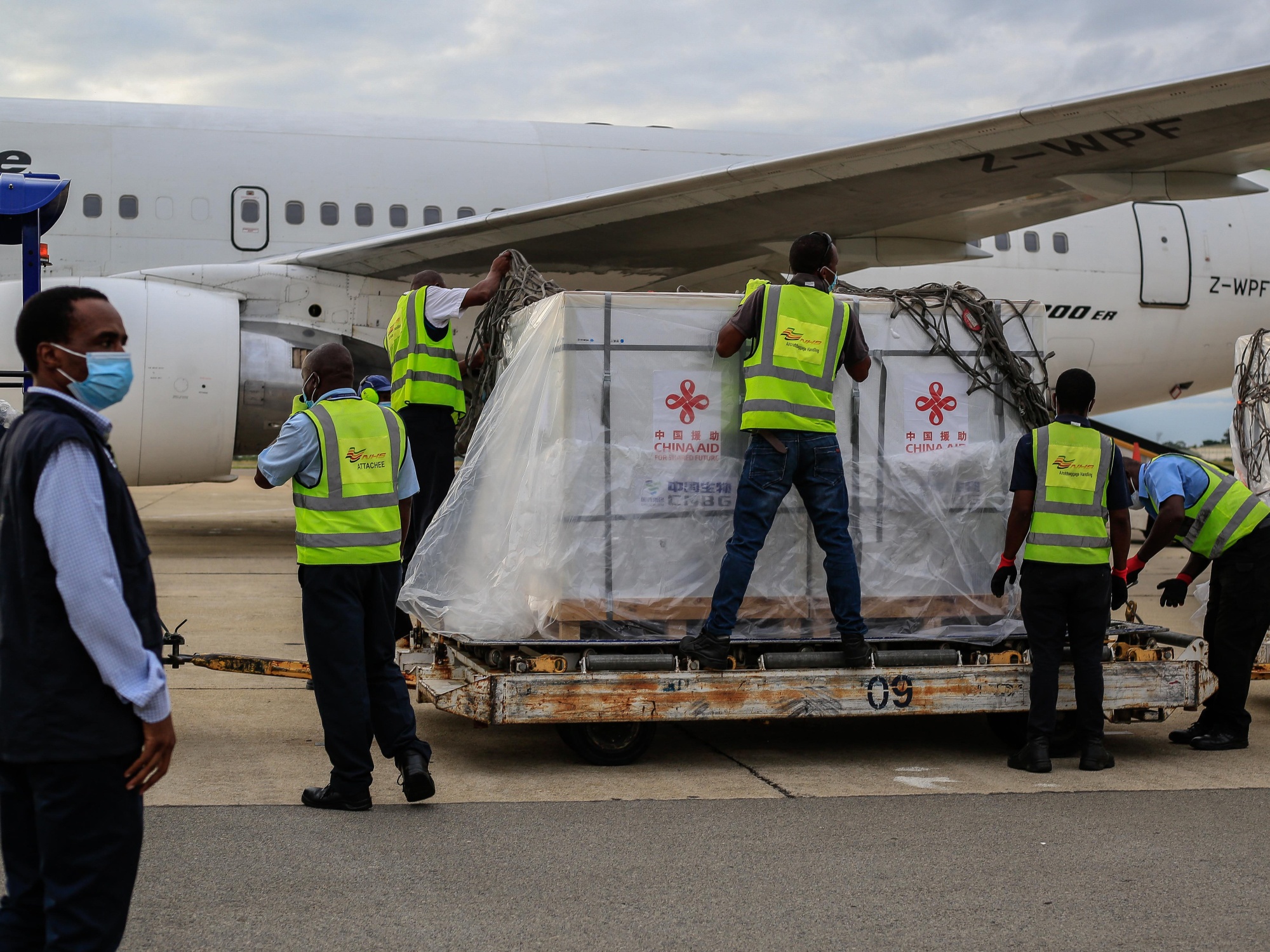 Airport employees unseal a shipment of Sinopharm Covid-19 vaccine at Harare International Airport on Feb. 15.