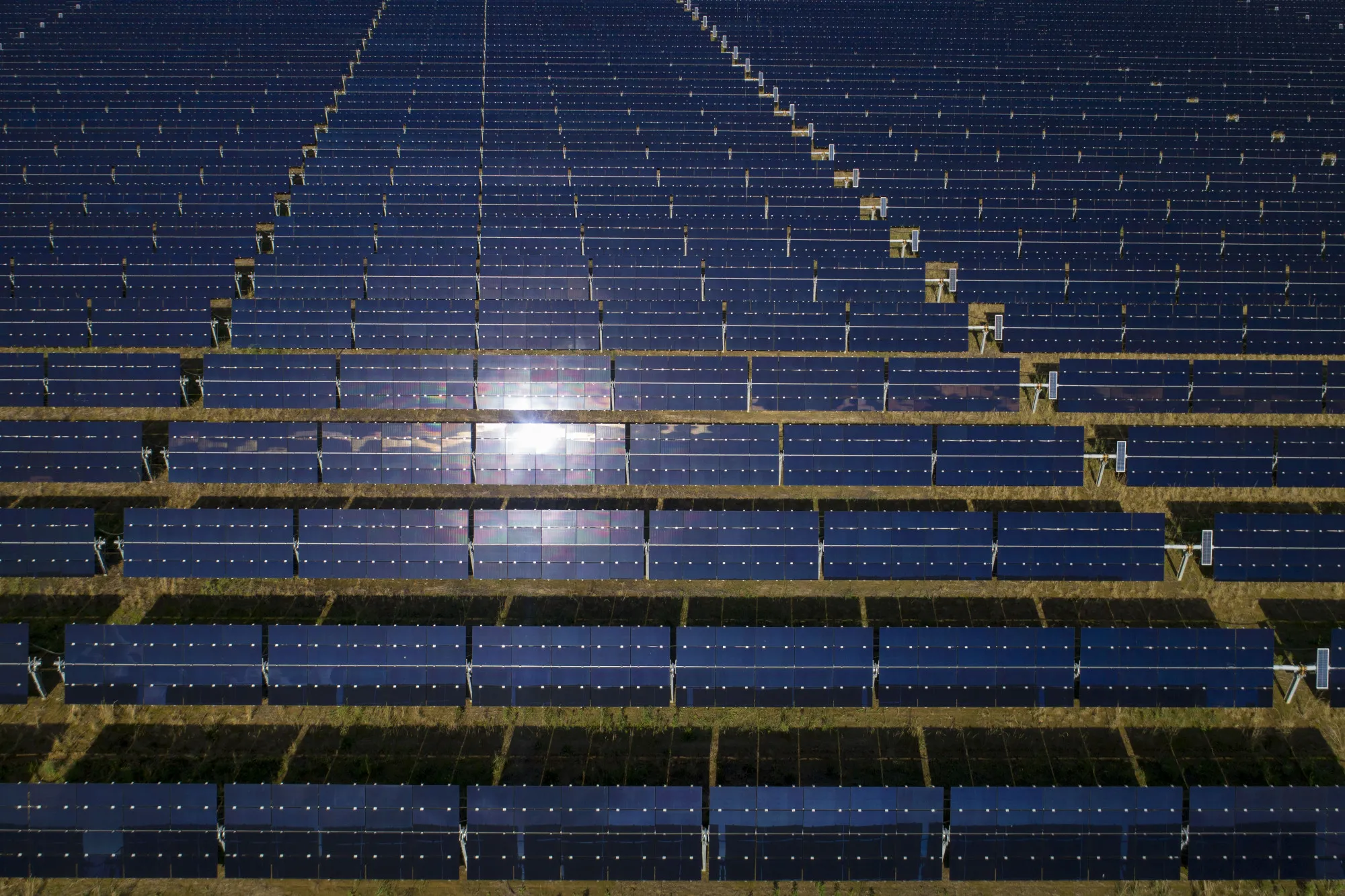 Solar panels stand at a solar generating facility 