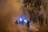 TOPSHOT - Police fire tear gas at protesters near the government headquarters in Hong Kong on July 2, 2019. - Riot police fired tear gas as they attempted to dislodge anti-government protesters in the early hours of the morning of July 2 in chaotic scenes in the heart of Hong Kong. (Photo by Anthony WALLACE / AFP) (Photo credit should read ANTHONY WALLACE/AFP/Getty Images)