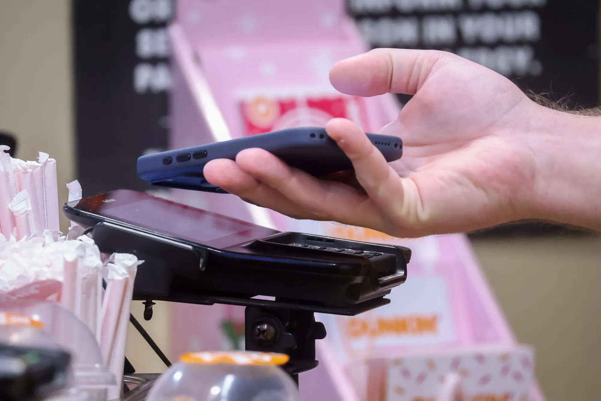 A customer makes a purchase with a phone at a store in New York.