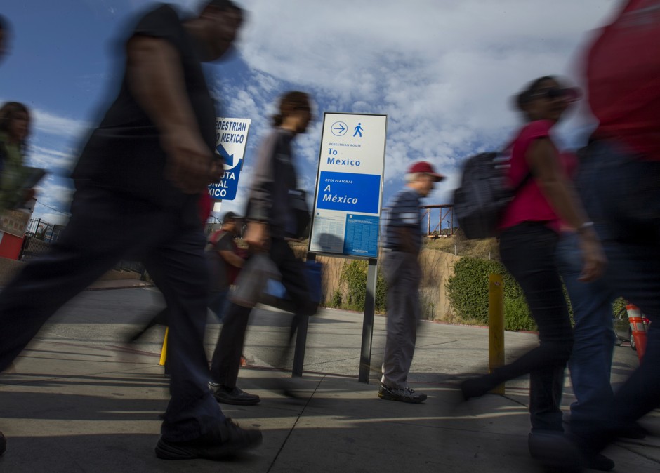 Pedestrians walk to the Mexican border in San Ysidro, California.