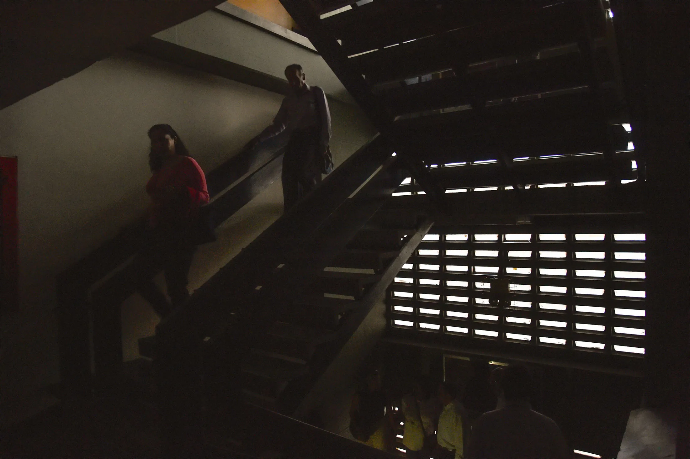 People evacuate the Venezuelan National Assembly building during a power outage in Caracas on March 25. 