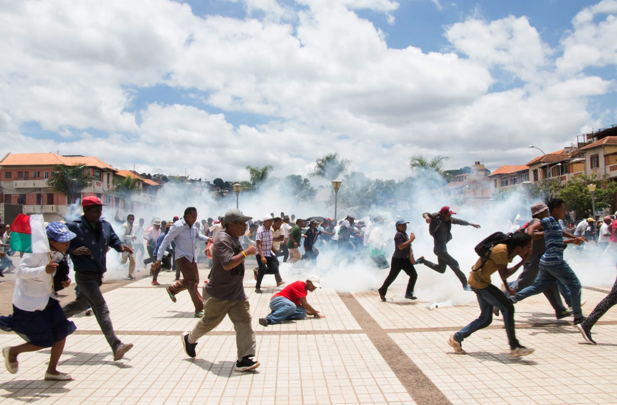 Supporters of Madagascan presidential candidate Marc Ravalomanana scramble as security forces fire tear gas during a demonstration in Antananarivo on Jan. 2, 2019.