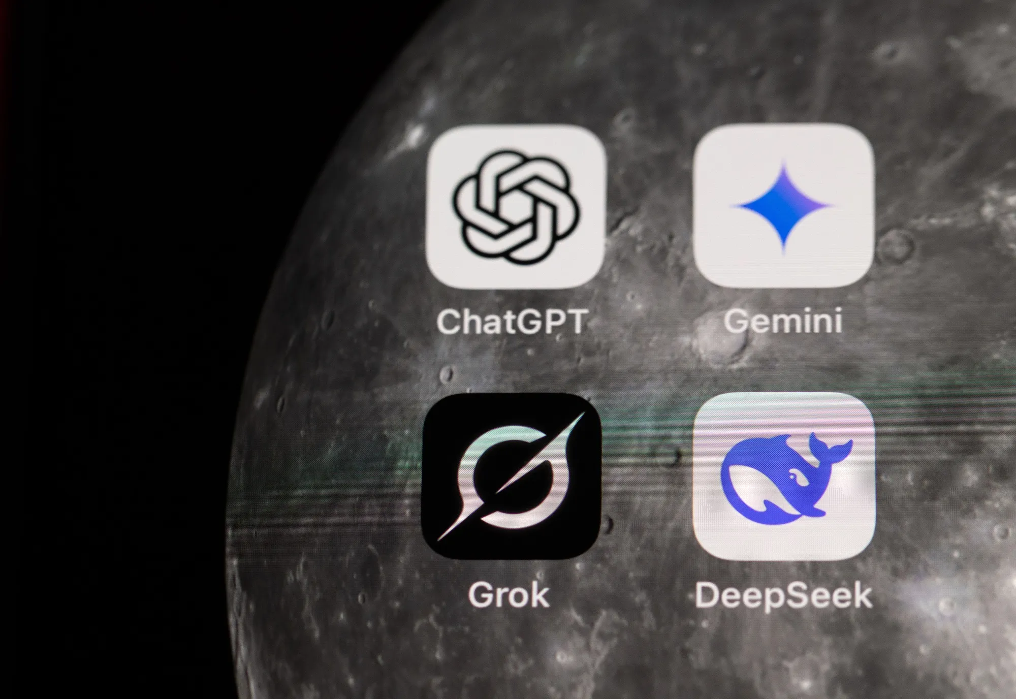 App icons for ChatGPT, Gemini, Grok and DeepSeek on a smartphone.