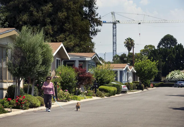 Alba Salciccia, walks her dog, at the Winchester Ranch mobile home park in San Jose, Calif., on July 31, 2015.
