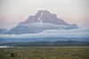 The Grand Teton mountain range is seen from the Jackson Lake Lodge during the Jackson Hole economic symposium, sponsored by the Federal Reserve Bank of Kansas City, in Moran, Wyoming, U.S., on Friday, Aug. 25, 2017. The world's two most powerful central bankers on Friday delivered back-to-back warnings against dismantling tough post-crisis financial rules that the Trump administration blames for stifling U.S. growth.
