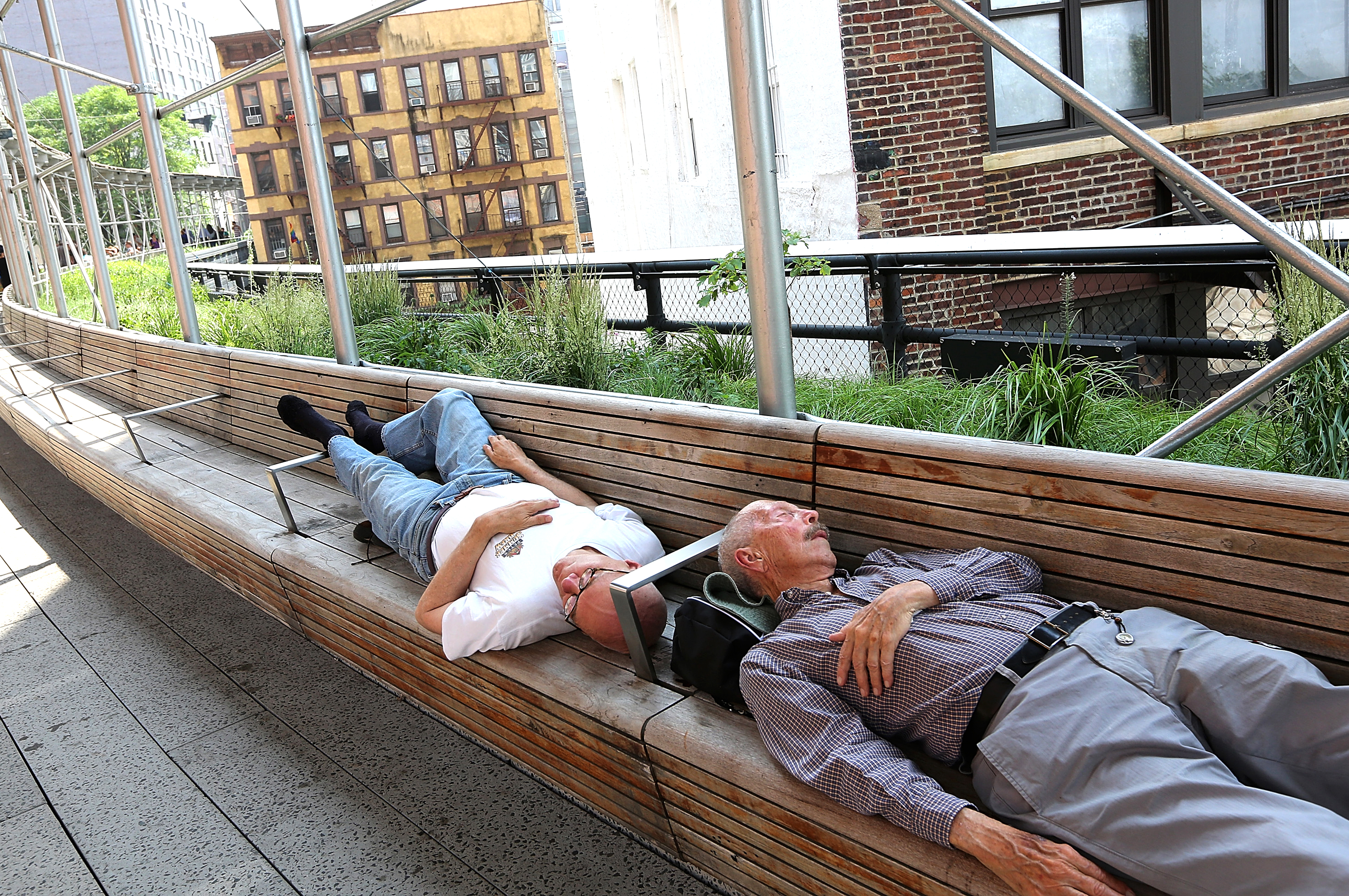 People sleep in the shade in Manhattan's High Line Park on June 25, 2013 in New York City. Photographer: Mario Tama/Getty Images