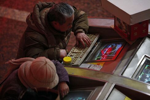 Investors Monitor Stock Prices In Shanghai