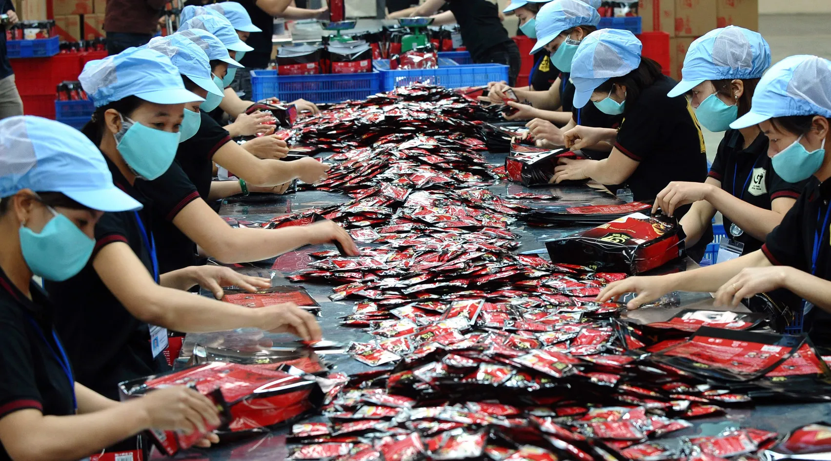 This picture taken on March 28, 2012 shows employees working at the newly opened 100 million USD instant coffee factory of the Trung Nguyen Coffee Group in the northern province of Bac Giang. Specialised in producing its popular G7 instant coffee brand, the factory is the fifth one built in Vietnam by Trung Nguyen, the country's largest coffee producer. A world's leading coffee producer, Vietnam exports more than 1.2 million tons of coffee each year. AFP PHOTO / HOANG DINH Nam (Photo credit should read HOANG DINH NAM/AFP/Getty Images)
