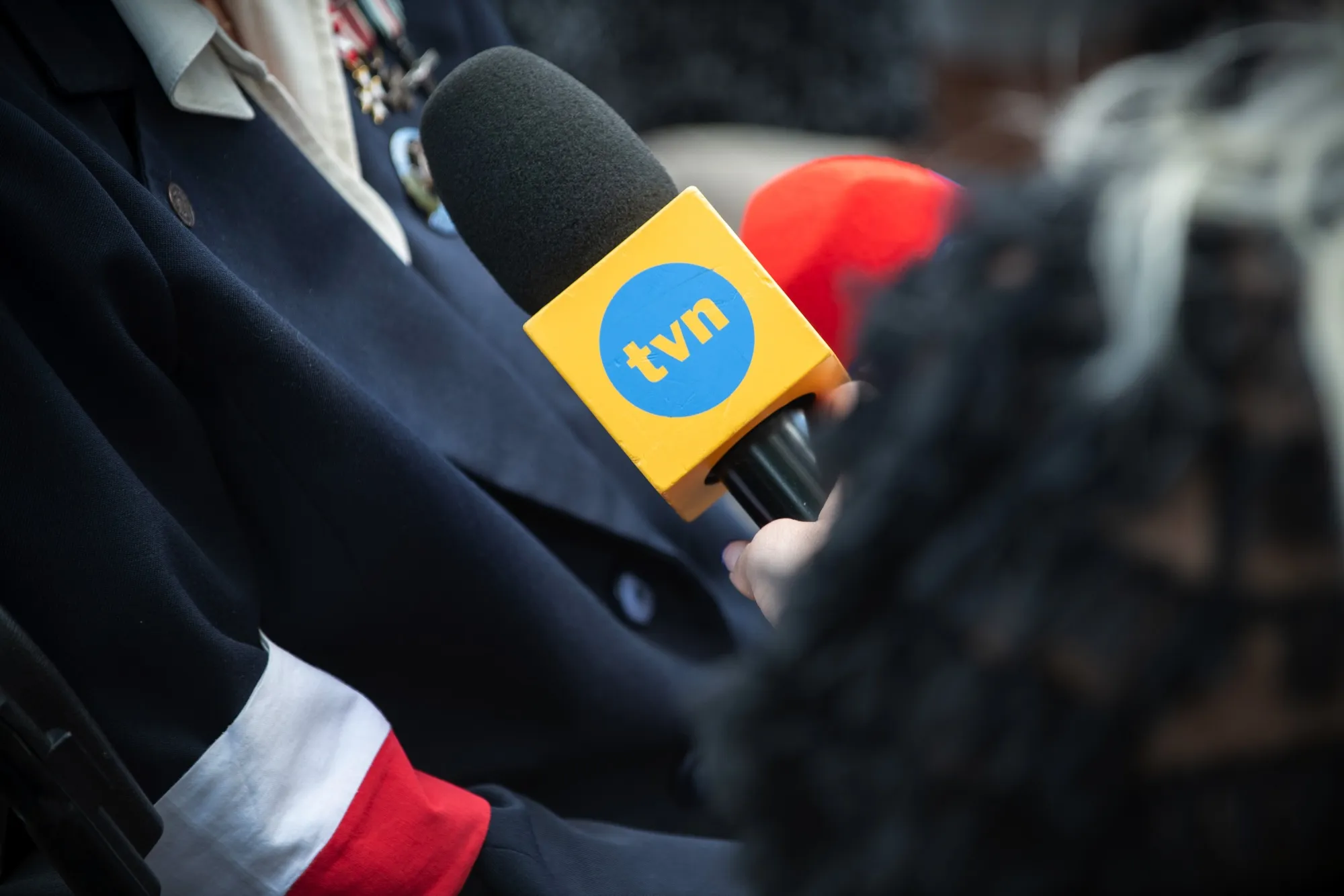 A TVN24 news reporter conducts interviews in Warsaw.