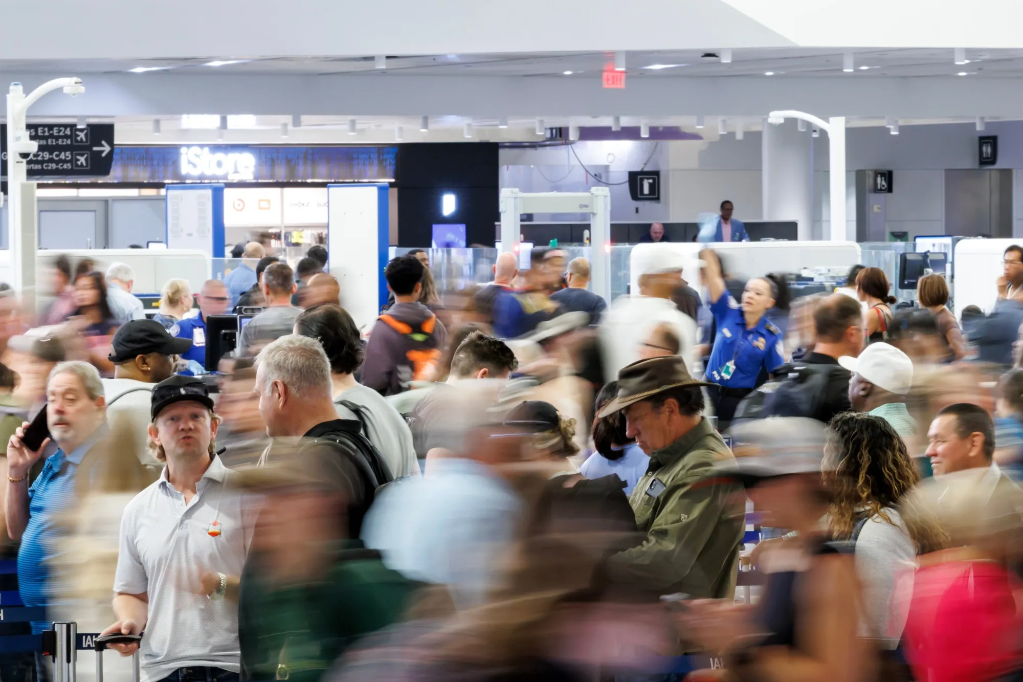 Travelers wait in line at a Transportation Security Administration (TSA) checkpoint at George Bush Intercontinental Airport (IAH) in Houston on March 26.