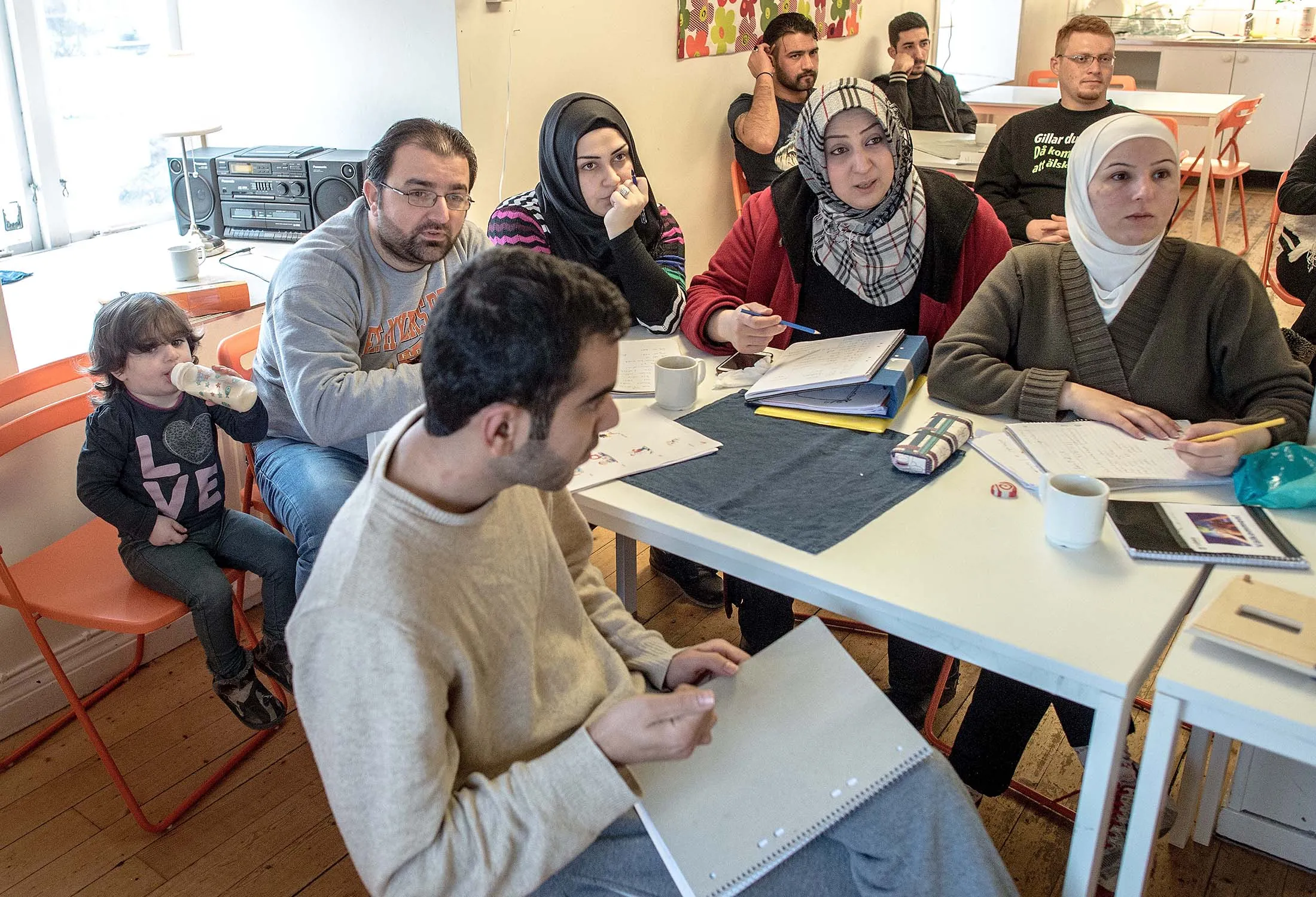 Refugees attend a Swedish language class in Vattendroppen, Sweden.
