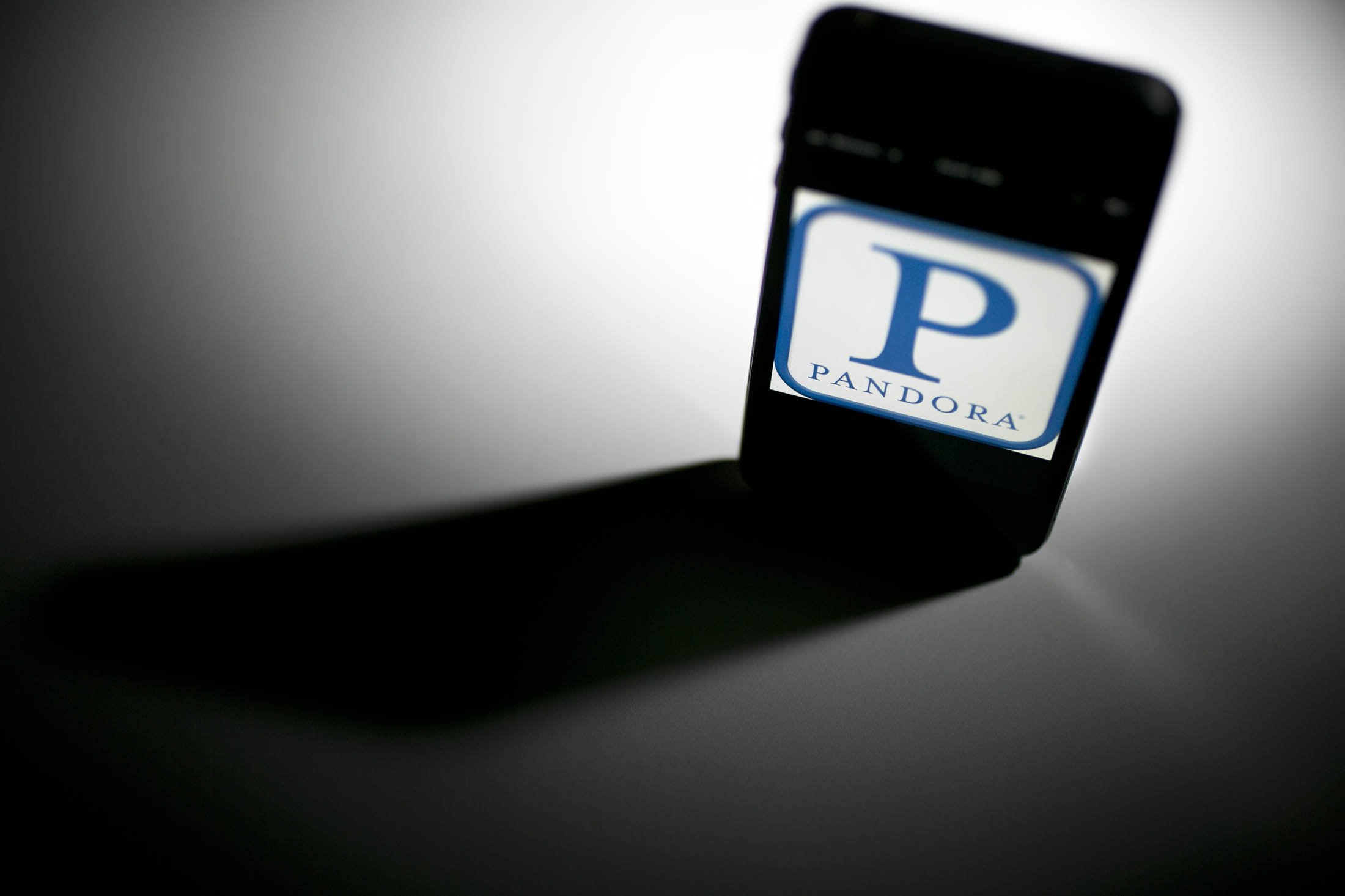 The Pandora Media Inc. logo is seen on an Apple Inc.
