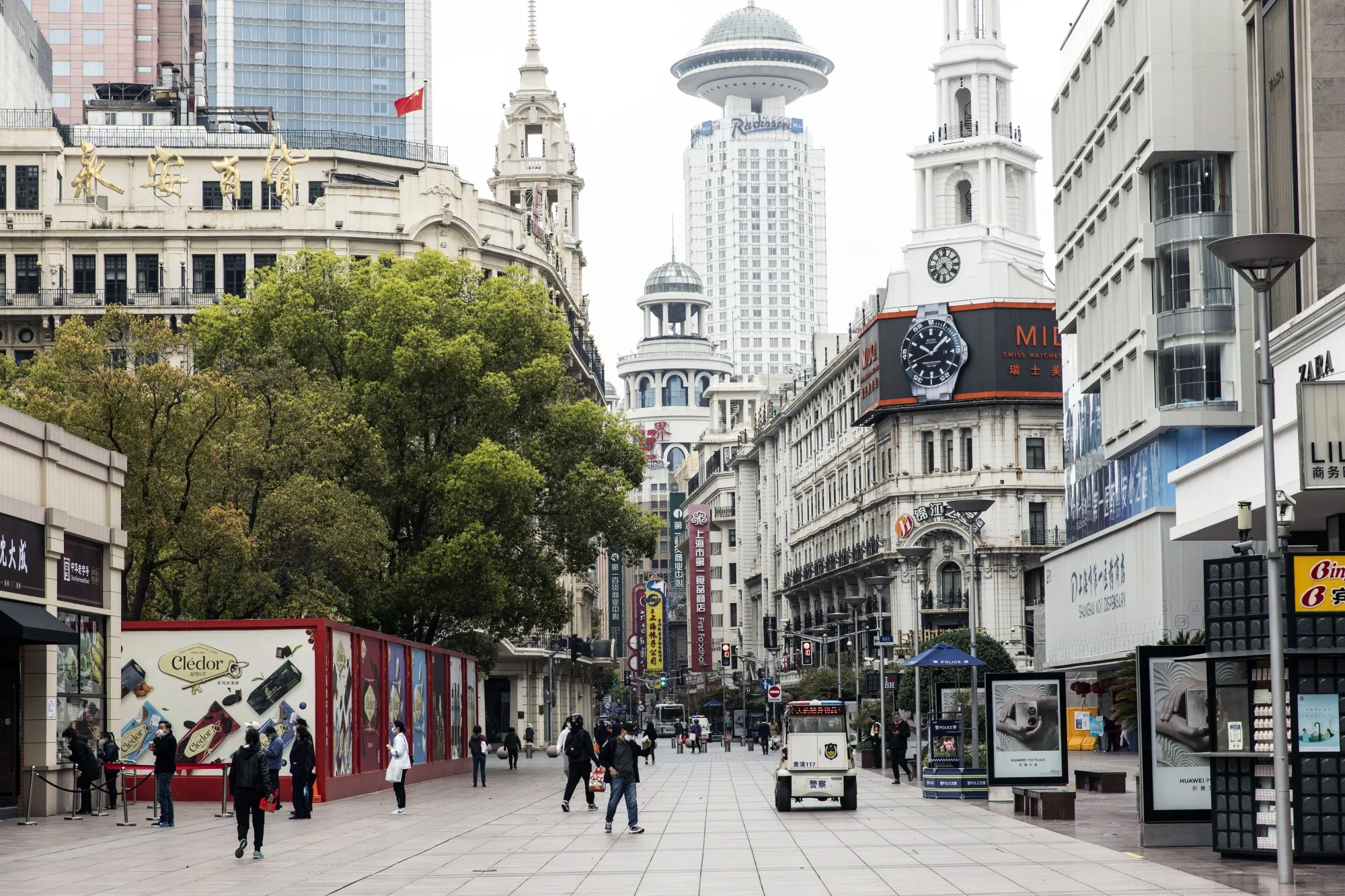 Pedestrians along the near-empty Nanjing Road shopping street in Shanghai, China.