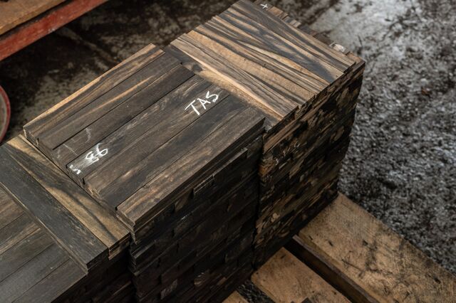 Stacks of striped ebony are processed for fretboards at the Crelicam mill Taylor co-owns in Yaounde, Cameroon. The guitar maker's Ebony Project this year met a goal of planting 15,000 trees for future generations.