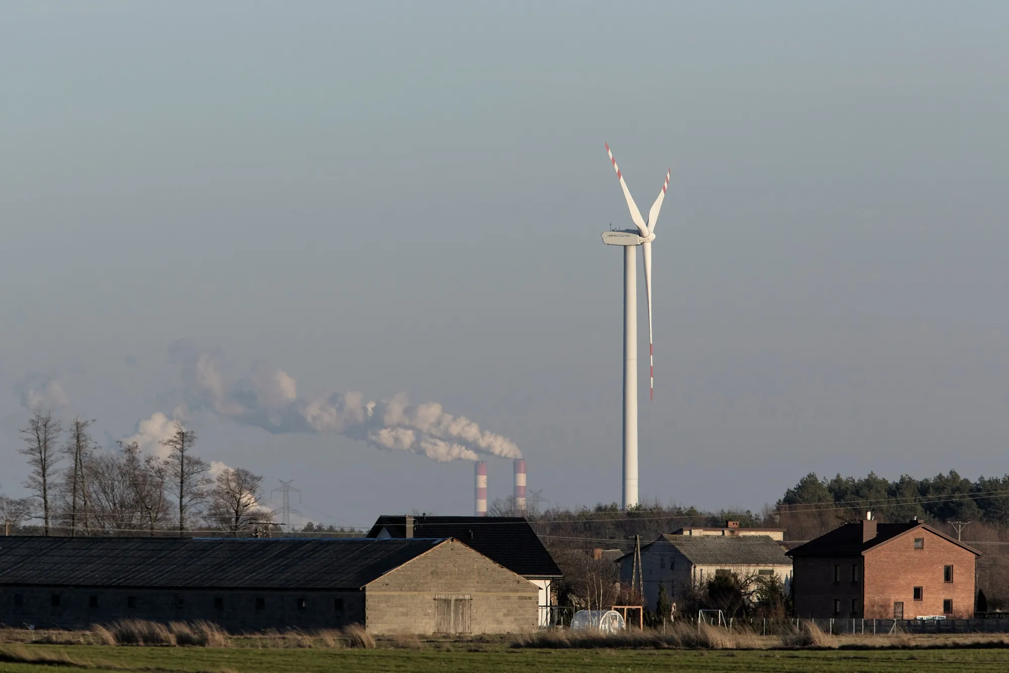 A wind turbine&nbsp;near the a coal powered power plant in Rusiec, Poland, in 2022.&nbsp;