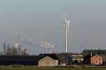 A wind turbines near the Belchatow coal powered power plant, operated by PGE SA, in Rusiec, Poland, on Sunday, Feb. 13, 2022. Poland's Prime Minister Mateusz Morawiecki has argued power prices are under pressure as the county, which relies on coal for more than 70% of power, faces massive investments to meet EU climate goals.