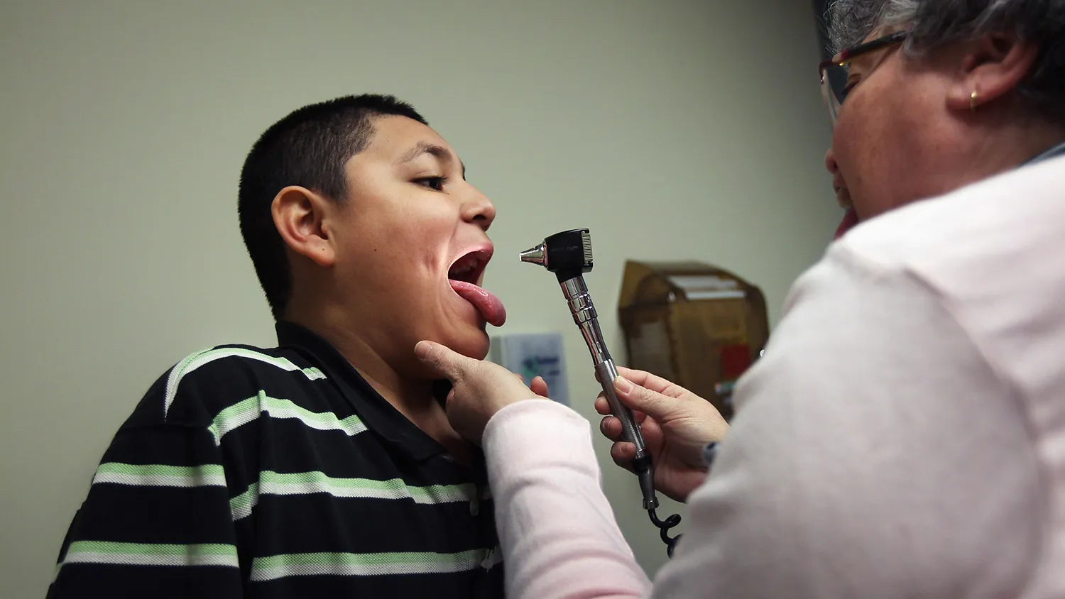 AURORA, CO - MARCH 27: Medical assistant Ann Valdez gives Christian Casteneda, 12, a physical at a community health center on March 27, 2012 in Aurora, Colorado. The center, called the Metro Community Provider Network, has received some 6,000 more Medicaid eligable patients since the healthcare reform law was passed in 2010. Expansion of such clinics nationwide is considered key to serving the millions more patients set to be be covered by Medicaid if the healthcare reform passes the current challenge in the Supreme Court. Preventative health services and treatments at community health centers are also designed to reduce emergency room expenditures, which are up to 10 times more costly.
