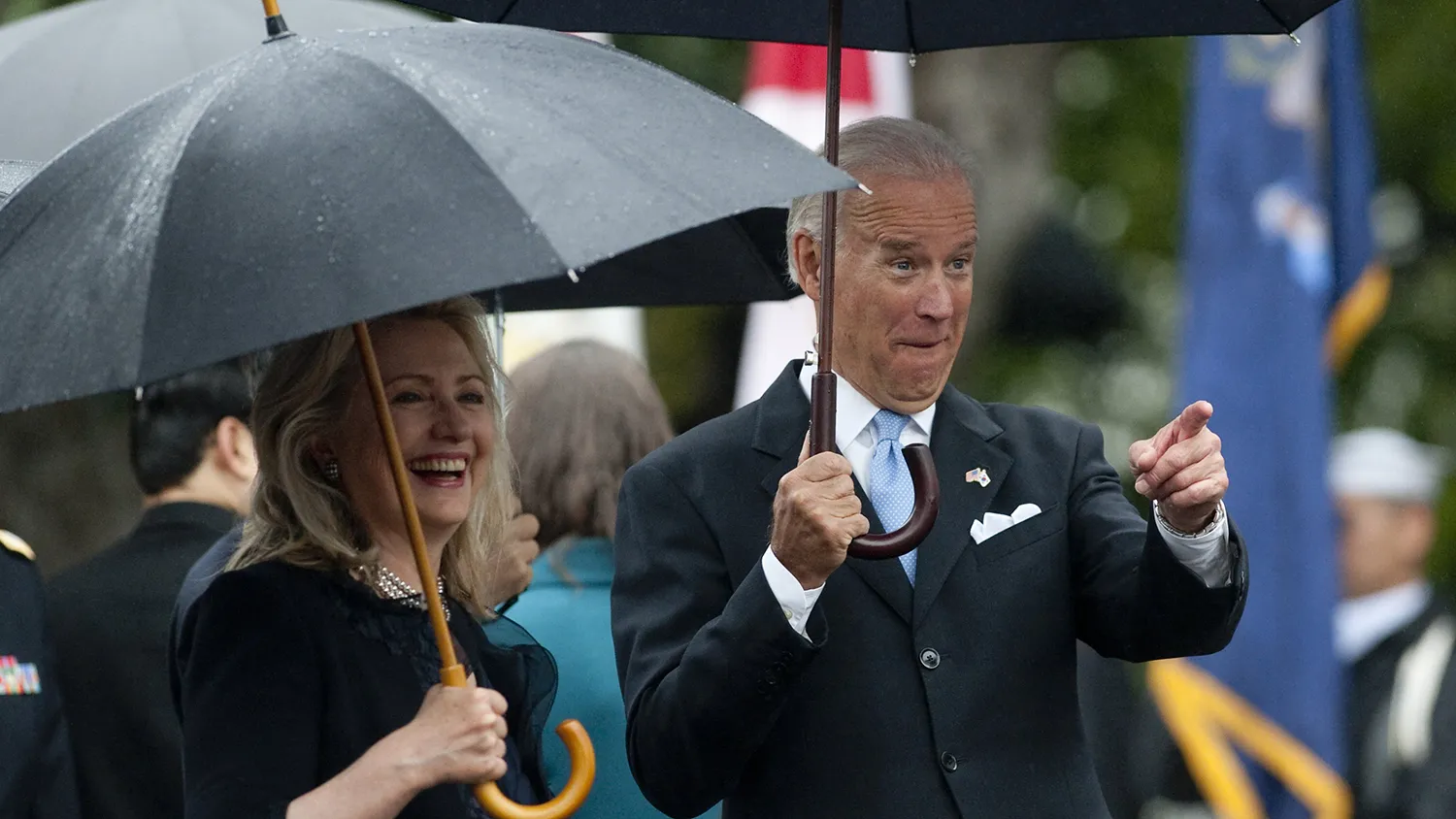 US Vice President Joe Biden points to the crowd alongside Secretary of State Hillary Clinton as US President Barack Obama welcomes South Korean President Lee Myung-bak during a State Arrival Ceremony on the South Lawn of the White House in Washington, DC, on October 13, 2011.
