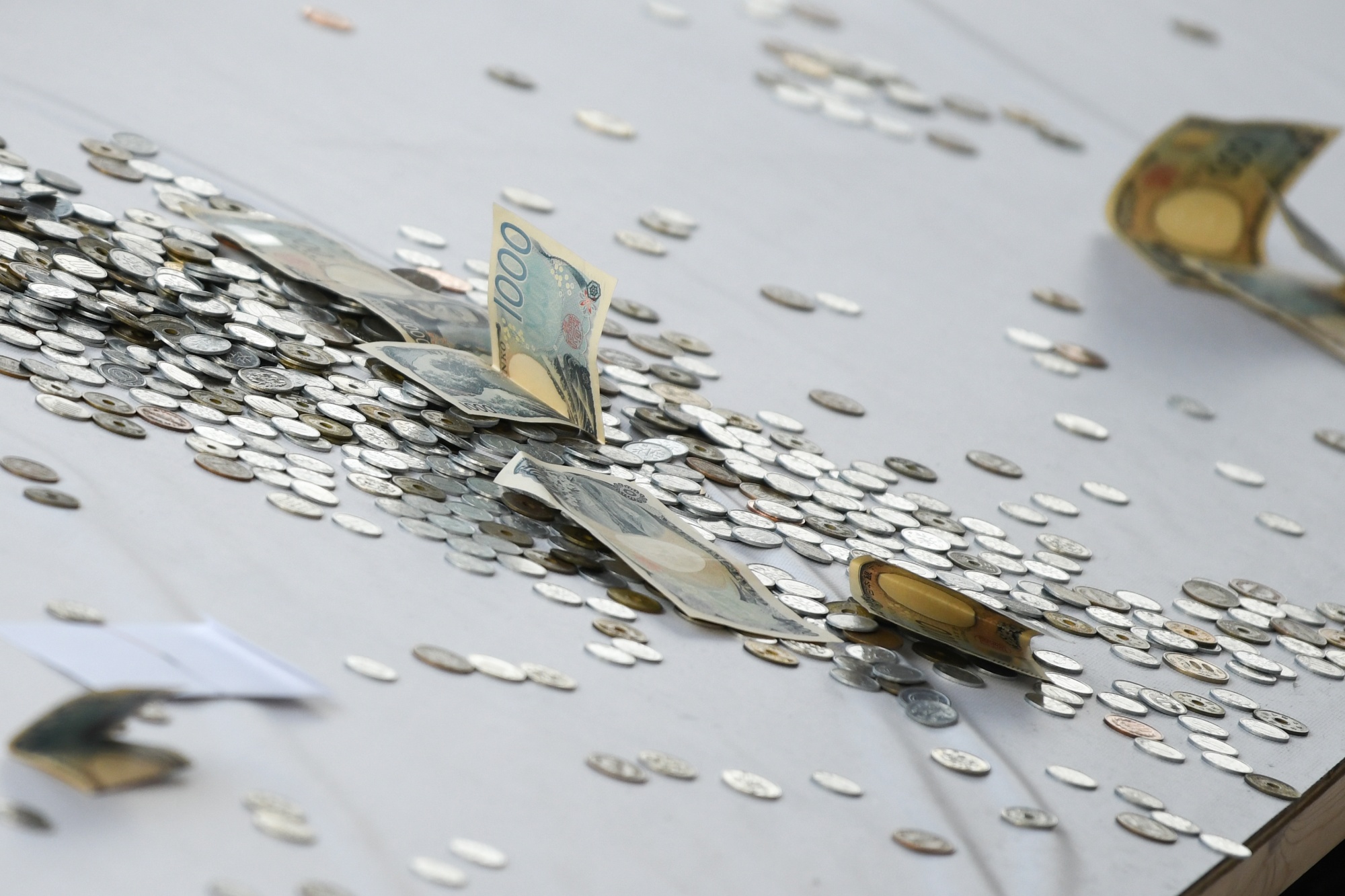 Donations in an offertory box at the Kanda Myojin shrine on the first business day of the year in Tokyo, Japan, on Monday, Jan. 5, 2026. Japan’s stocks started 2026 strong as tech shares rallied to catch up with their American peers and a weaker yen supported exporters.