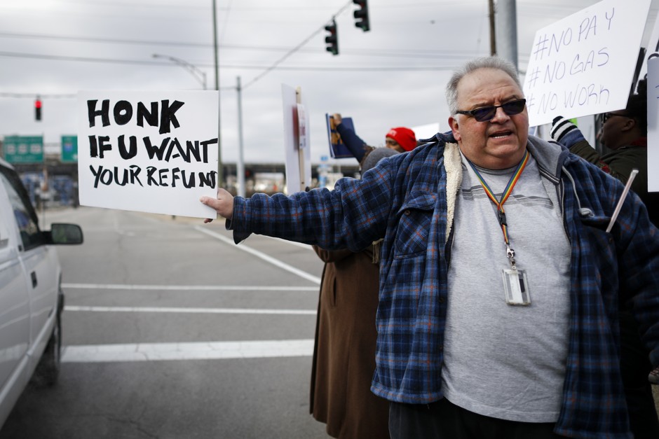 An IRS tax examiner protests outside his office during the partial government shutdown in January.