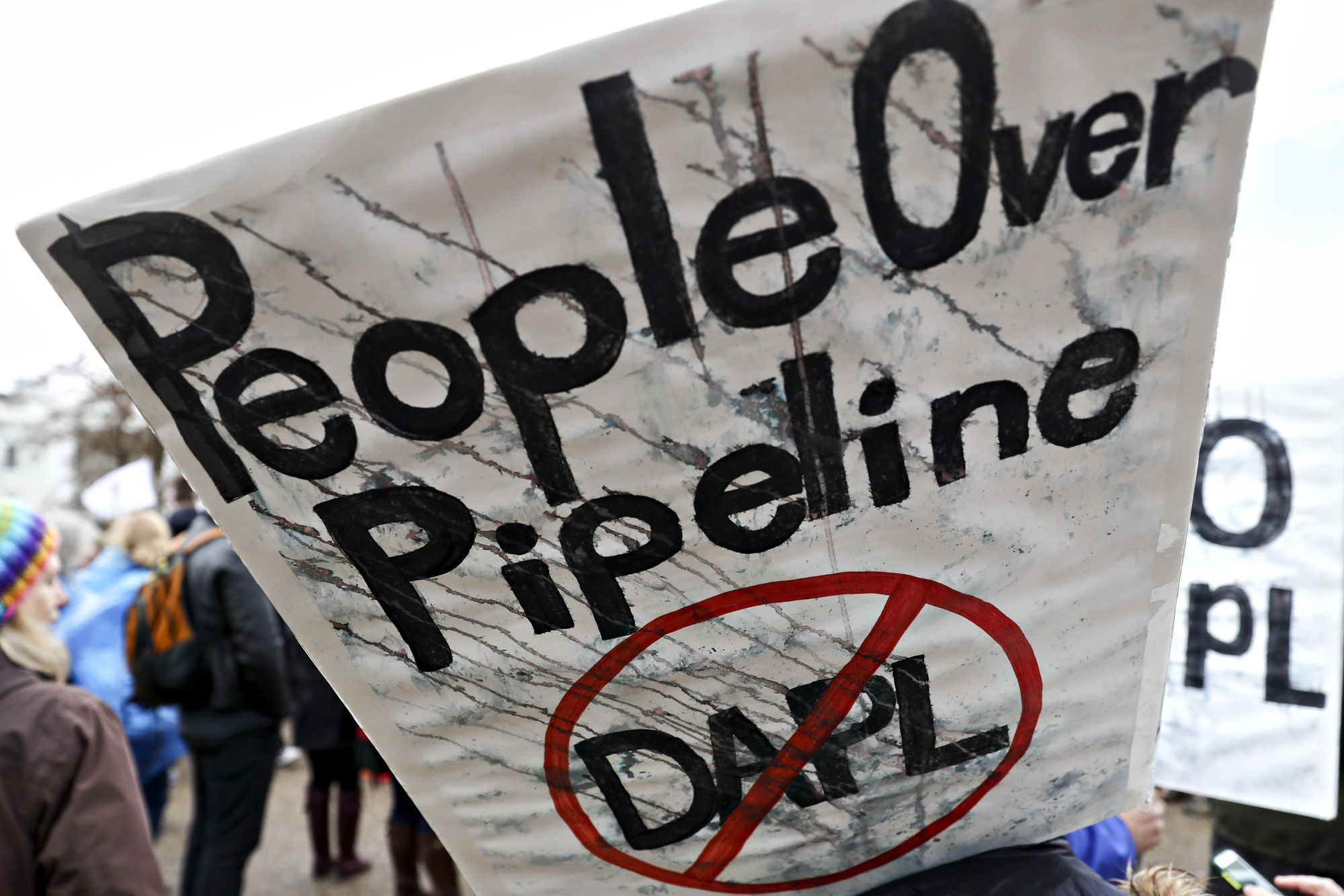 A demonstrator holds a sign during a protest against the Dakota Access pipeline in Washington in March 2017.&nbsp;