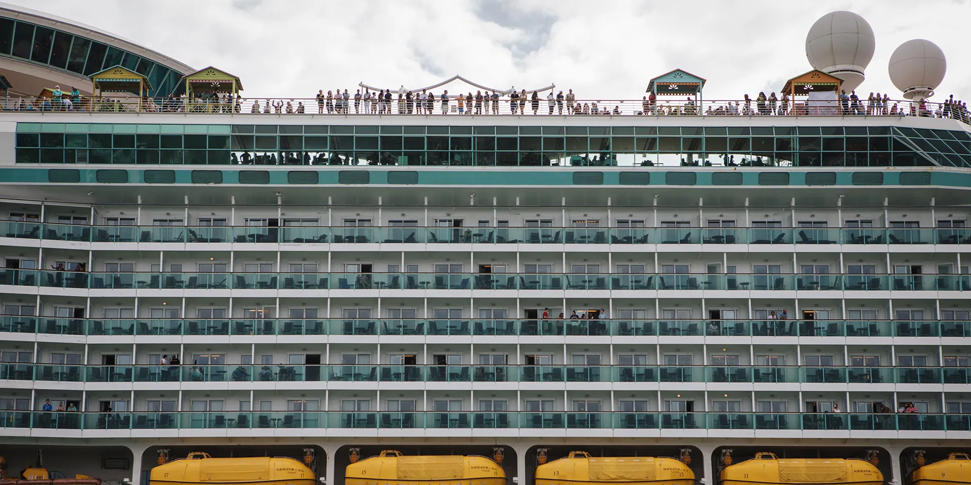 Passengers stand on board the Royal Caribbean Cruises Ltd. Navigator Of The Seas.