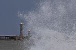 Waves hit the sea wall at Whitby, Yorkshire.