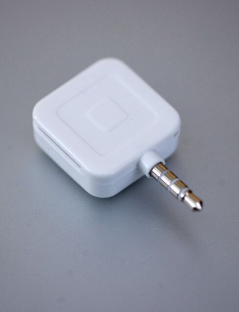Square, a credit card reader is arranged for a photo.