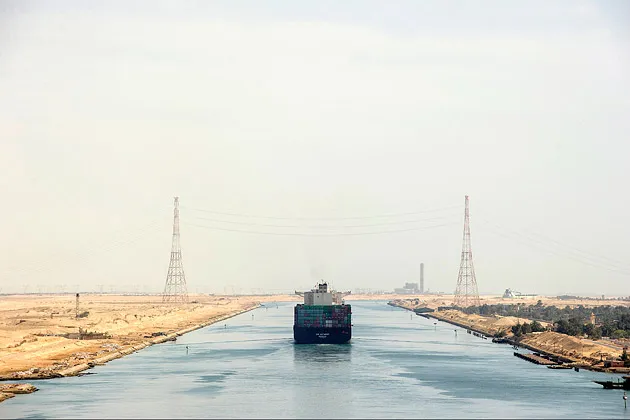 A container ship heads south in the Suez Canal toward Suez, Egypt, on Apr. 6