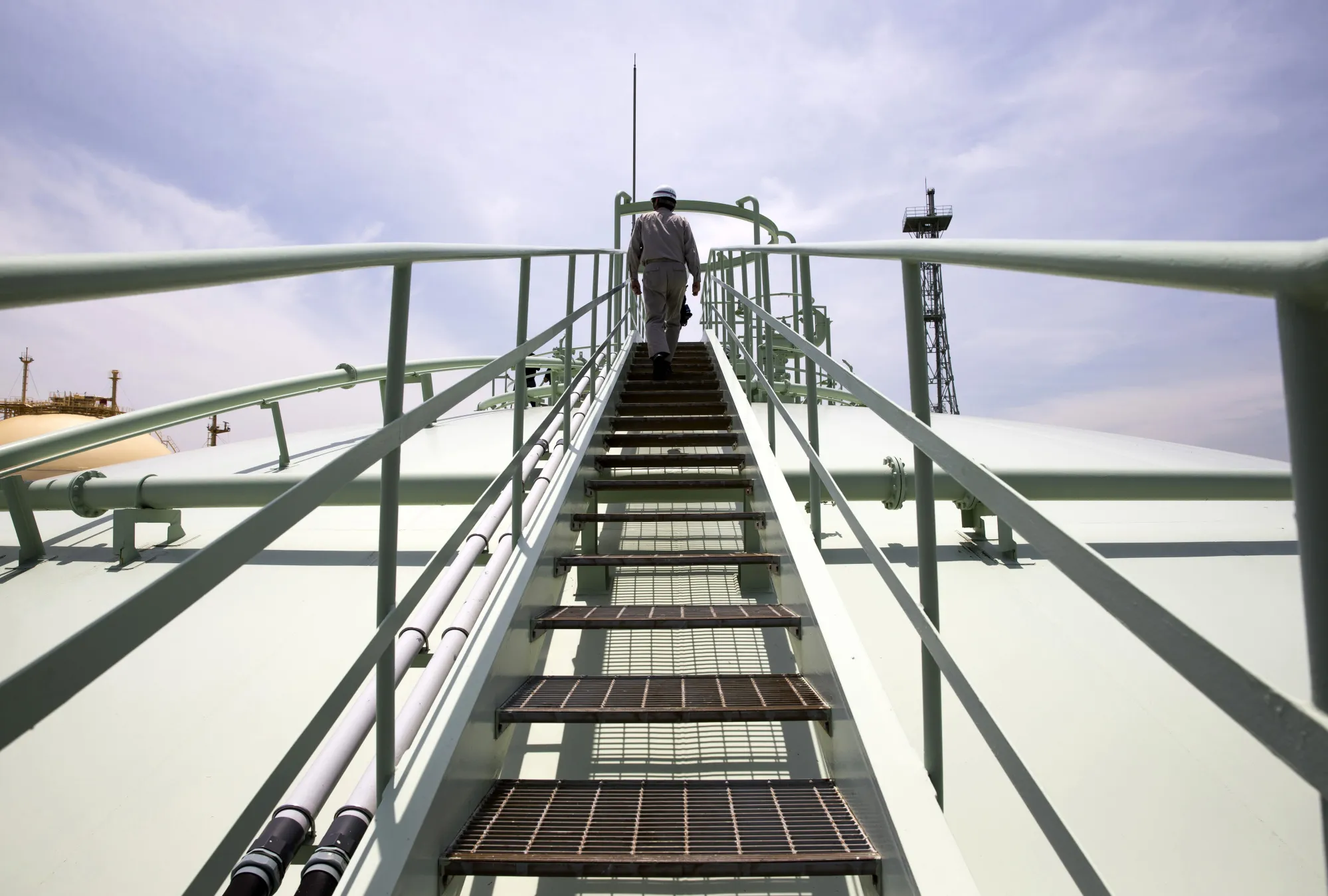 An employee walks up a flight of steps on an in-ground liquefied natural gas&nbsp;tank in&nbsp;Japan.