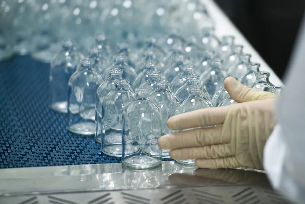 An employee arranges medicine bottles during the manufacture of pharmaceuticals inside Teva Pharmaceutical Industries Ltd.'s new factory in Godollo, Hungary.