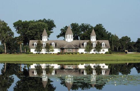 Padua Stables, looking across the lake at the stallion barn. The property includes 11 barns and 202 stalls in total, on 768 acres.