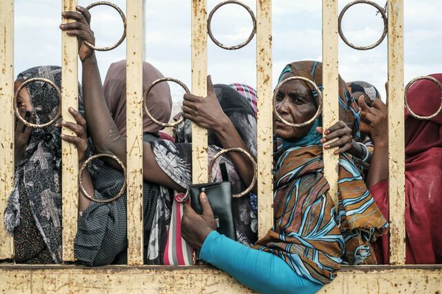People wait in line during the distribution of cash by the UN World Food Programme at the camp.