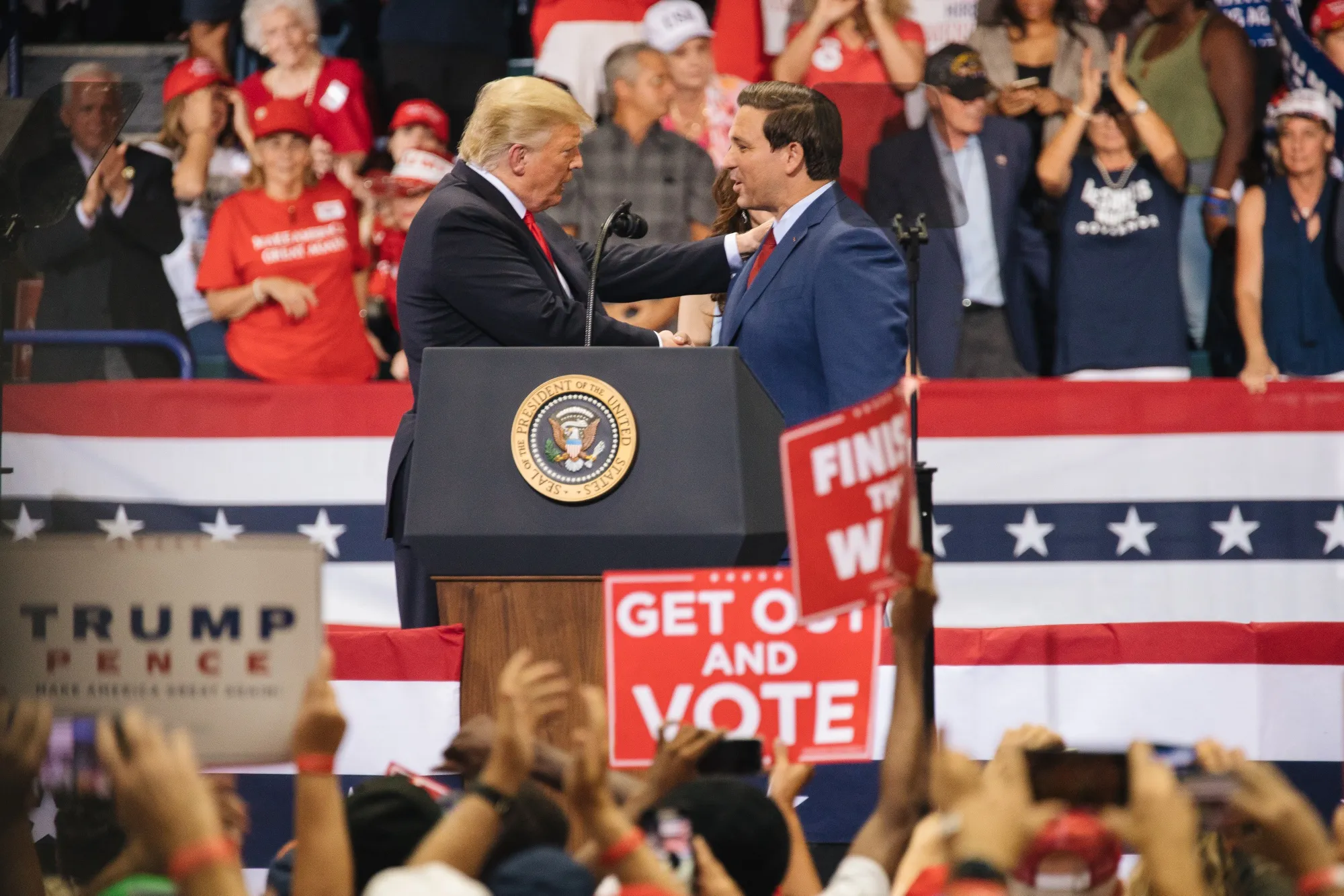 Donald Trump shakes hands with Ron DeSantis.